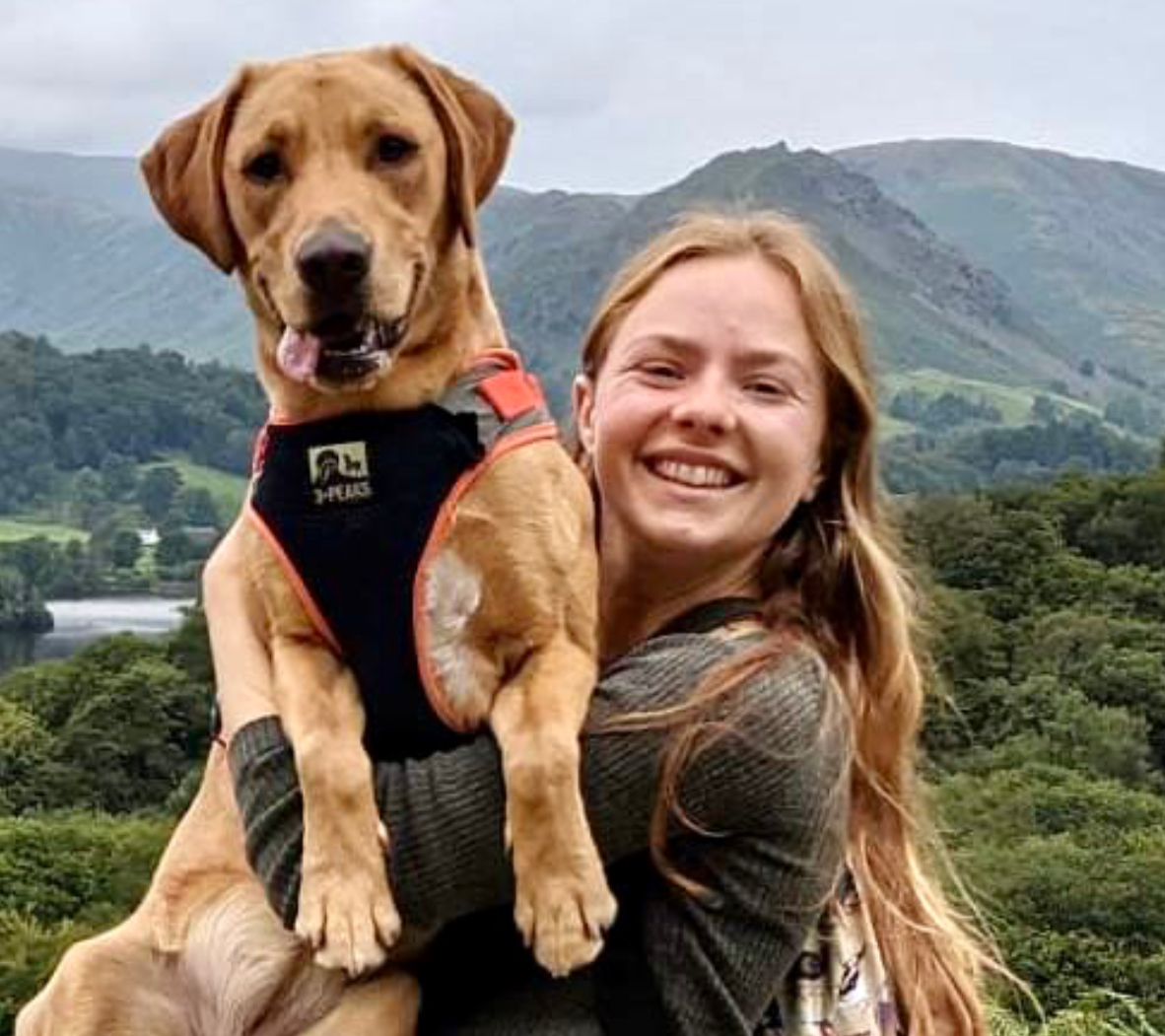 picture of Molly Beetham (right) on a hillside, with Daisy the adorable Labrador
